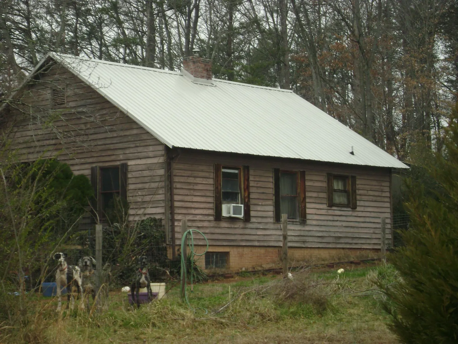 White metal roof on an old wood sided farmhouse, from a Metal Roof Installation job in Acushnet